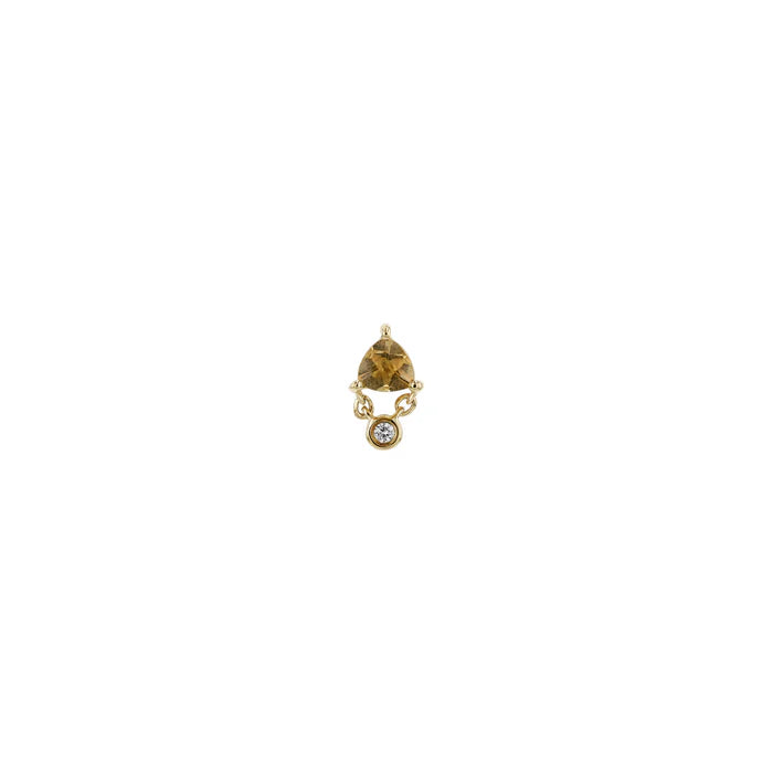Gold earring with a brown gemstone on a white background