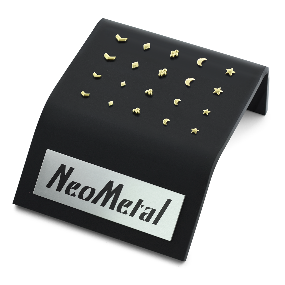 A 20 piece black acrylic display with various sizes of 18K Yellow Gold Chevrons, Diamonds, Multi-Beads, Moons, and Stellar Ends