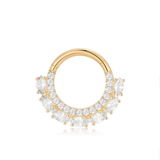 Gold ring with clear gemstones on a white background