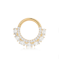 Gold ring with clear gemstones on a white background