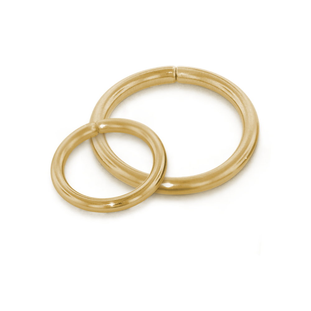 Two of our 18 gauge 18 karat gold seam rings overlapping, all in yellow gold
