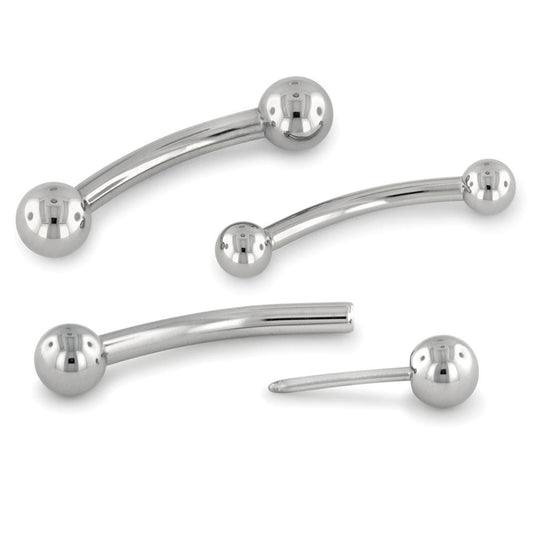 Two threadless titanium curved barbells with titanium ball ends, and another with one of the ball ends removed.